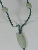 A Strung Vase Shaped Jade Pendant