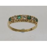 A Ladies 18ct Gold Ring Set With Diamonds & Emeral