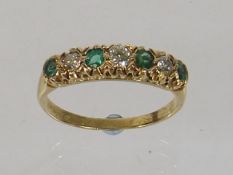 A Ladies 18ct Gold Ring Set With Diamonds & Emeral