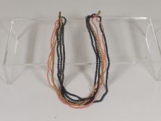 A 14ct Gold Bead & Coral Three Strand Necklace