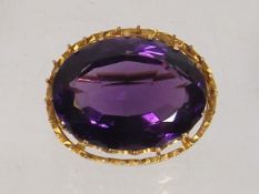 A Large Amethyst Brooch Set Within Frosted Gold Mo