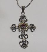 An Antique Silver Crucifix With Garnet Set In Yell