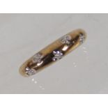 A Ladies 9ct Gold Band With Diamonds