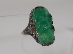 A White Metal Ring With Carved Jade Stone