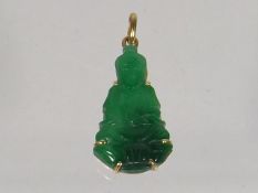 A Gold Mounted Jade Buddha