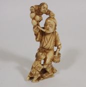 A Meiji Period Japanese Ivory Of Man With Two Boys