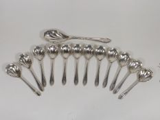 A Set Of Twelve Silver Shell Shaped Dessert Spoons