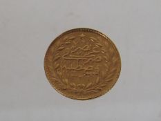 A Small Islamic Yellow Metal Coin