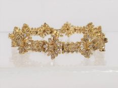 A Ladies Gold Bracelet With Baguette Cut Diamonds