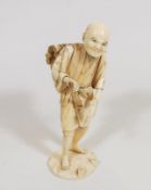 A Meiji Period Japanese Ivory Figure Of Man Carryi