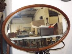 An Edwardian Oval Mahogany Framed Mirror With Inla