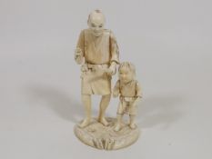 A Meiji Period Japanese Ivory Of Man With Boy