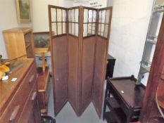 An Antique Mahogany Four Fold Screen With Hessian