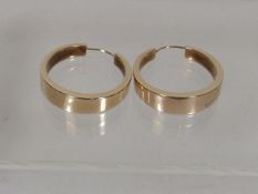A Large Pair Of Gold Ear Rings