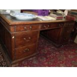 A Large Oak Pedestal Desk With Brass Handles