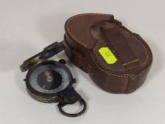 A Military Style Compass With Leather Case