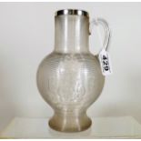 A Large Glass Ridged Water Jug With Silver Rim Wit
