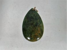 A Jade Pendant With Gold Mount