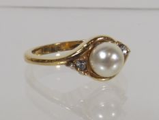 A Ladies Pearl & White Stone Yellow Metal Ring