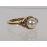 A Ladies Pearl & White Stone Yellow Metal Ring