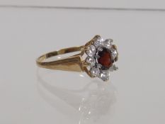 A Ladies 9ct Ring With Garnet & White Stone