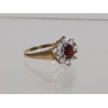 A Ladies 9ct Ring With Garnet & White Stone