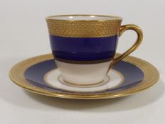 An early 20thC. American Belleek Gilded Cup & Sauc