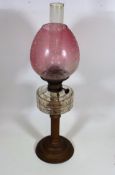 A Late Victorian Oil Lamp With Etched Cranberry Sh