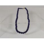 A Lapis Lazuli Necklace With Gold Clasp