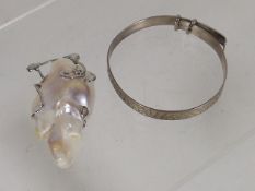 A Baby's Silver Bangle Twinned With Silver Mounted