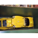 Two Bburago Diecast Cars & A Magazine Rack