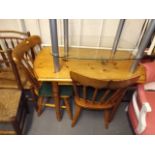A Small Pine Kitchen Table With Two Chairs