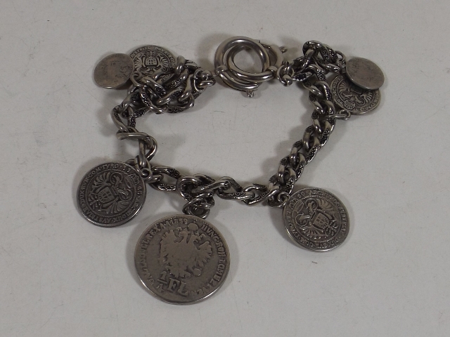 A White Metal Bracelet With Metal Coin Decor
