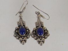 A Pair Of Silver Ear Rings With Blue Stone