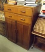An Oak Utility Cabinet With Cupboard & Two Drawers