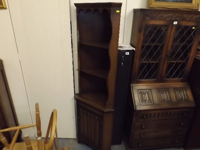 An Oak Corner Cabinet With Shelves