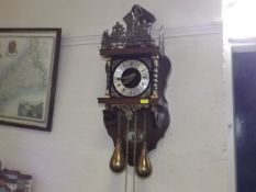 A Modern Wall Clock With Brass Weights
