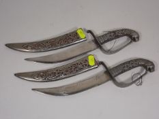 A Pair Of Islamic Style Daggers In White Metal She