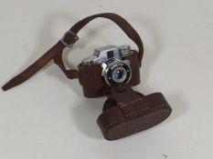 A Miniature Mycro Camera In Leather Case