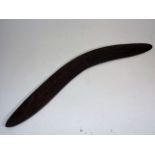 An Antique Boomerang With Carved Decor