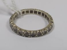 A Yellow Metal Eternity Ring With White Stones