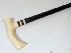 A Gents Antique Walking Cane With Ivory Pistol Gri