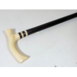 A Gents Antique Walking Cane With Ivory Pistol Gri