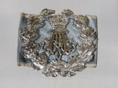 A White Metal Military Badge In Wreath With Crown