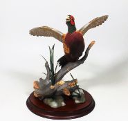 A Franklin Mint Porcelain Pheasant In Flight By A.