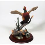 A Franklin Mint Porcelain Pheasant In Flight By A.