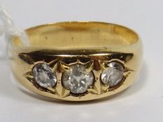 A Yellow Metal Three Stone Diamond Ring