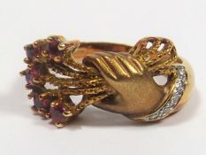 A 14ct Gold Diamond & Ruby Ring Of Hands Holding B