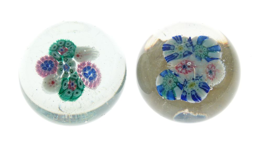 Two 19th Century St Mande glass paperweights, one with a six cane cluster, the other with a seven