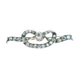 Late Victorian diamond lovers knot brooch, the central diamond of approximately 0.2 carats, 3.5cm